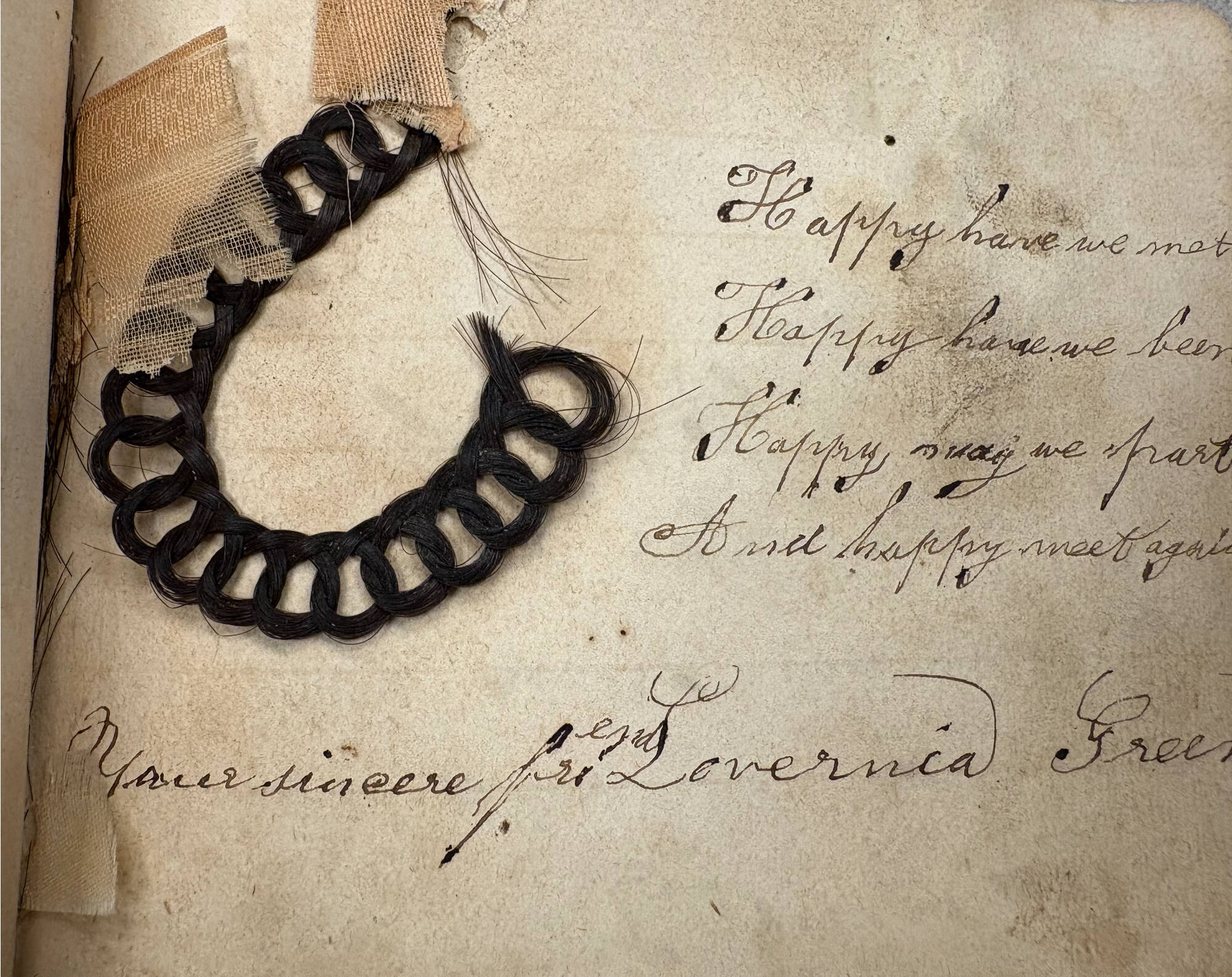 lock of braided hair taped into a book, courtesy of University Archives